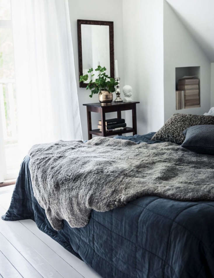 a swedish sheepskin looks casually luxe when draped on a bed. see out like 20