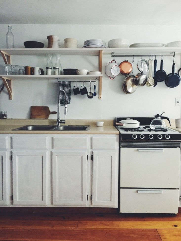 a utensil rail mounted to the underside of an open shelf in ceramic artist suzi 29