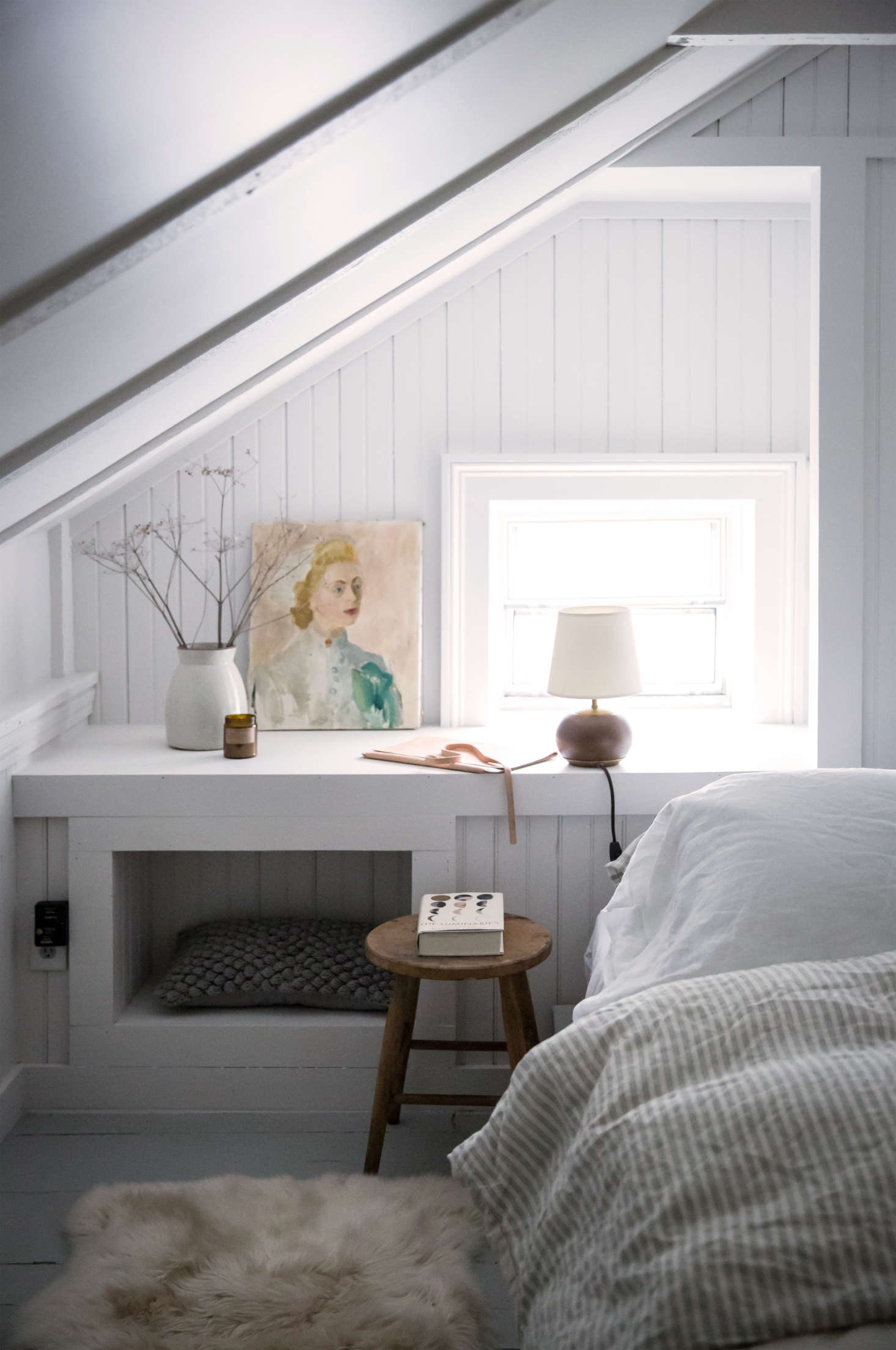 For an update in this historic Hudson Valley home, Tara and Percy created a cozy, yet contemporary, bedroom nook with beadboard painted in fresh white. Note how even the recessed shelf gets this textured treatment. (See: Old Soul: A Revolution-Era Hudson Valley Home Gets an Update from Jersey Ice Cream Co.) Photograph by Beth Kirby.