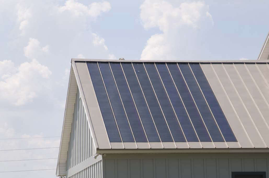 Photovoltaic (PV) panels integrated into a standing seam metal roof. Photograph via Fabral.