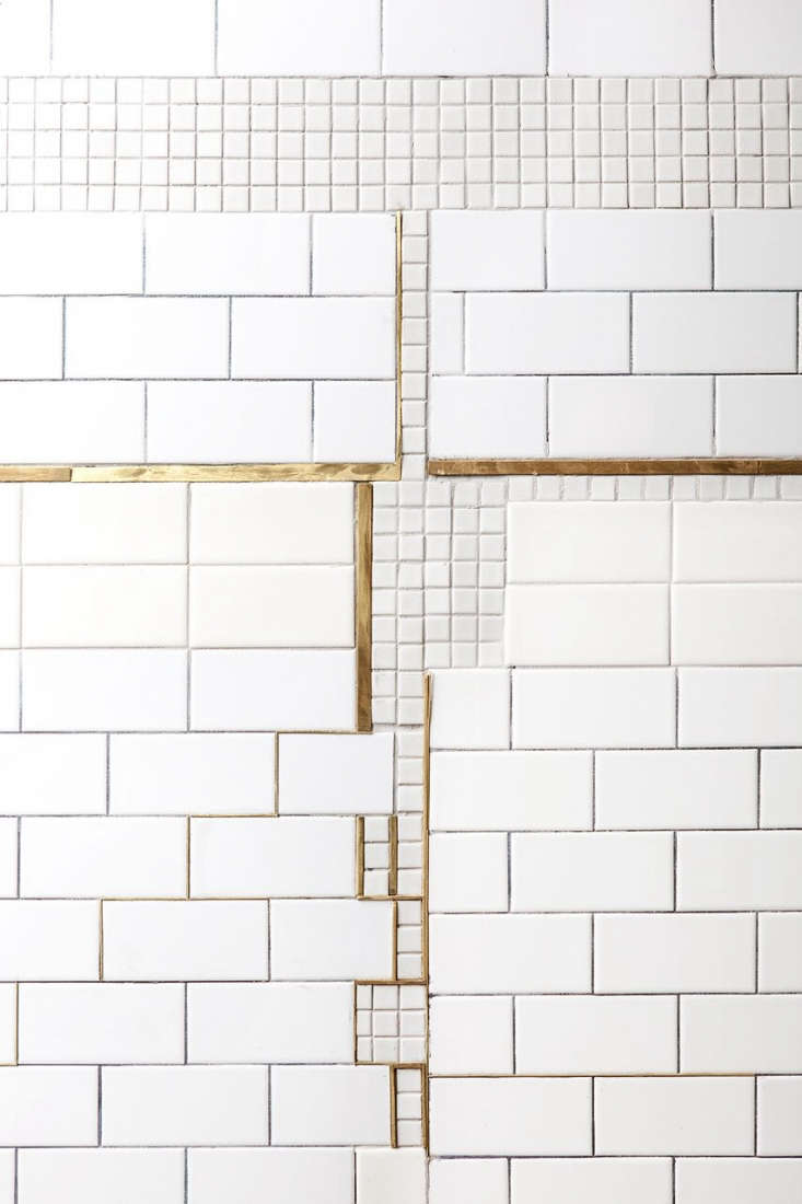 a patched subway tile wall in bauhaus on the bowery: de maria cafe in nyc. pho 9