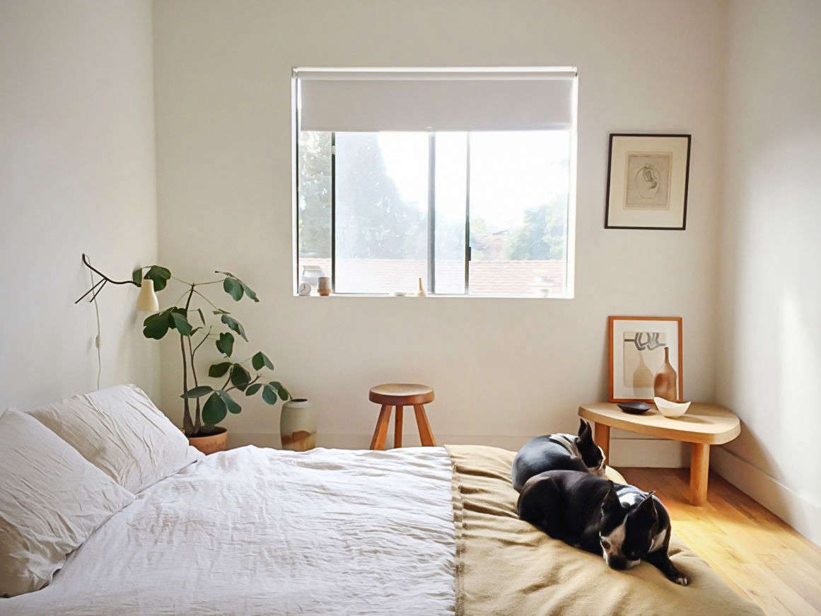 In the minimal bedroom, the couple