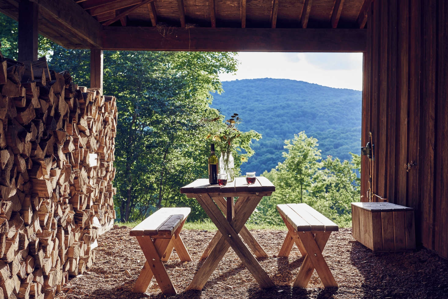 A handcrafted picnic table overlooking the valley is well-suited to an evening glass of wine.