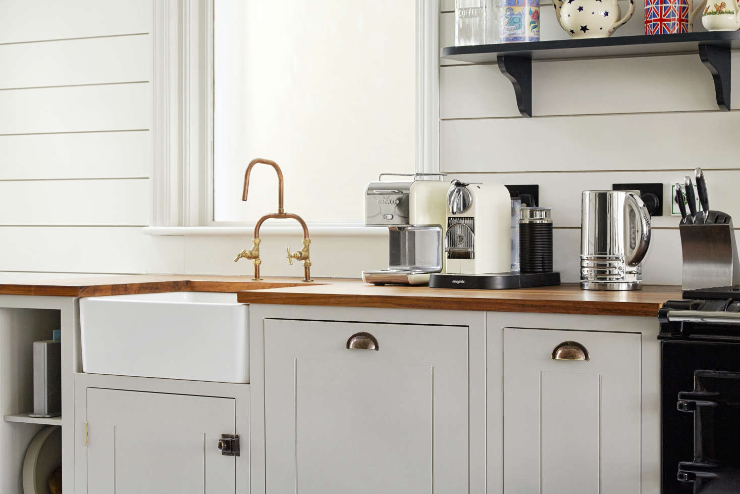 The butler sink, iroko countertop, and patinated brass pulls are also British Standard components. The copper piping faucet is another homemade project purchased on eBay: To create your own, see DIY Faucets Made from Plumbing Parts.