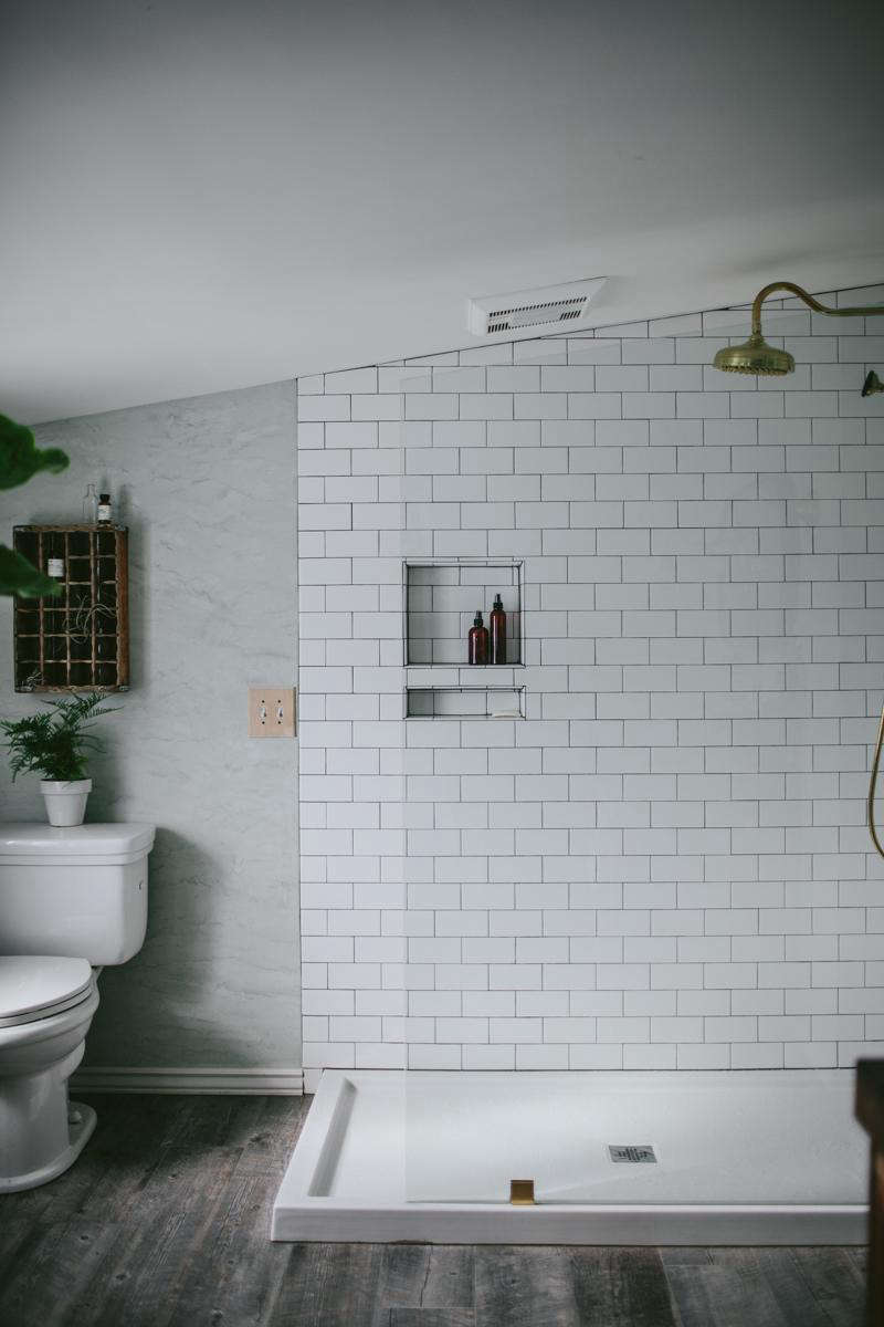 The shower has a simple glass wall to keep the space feeling open.