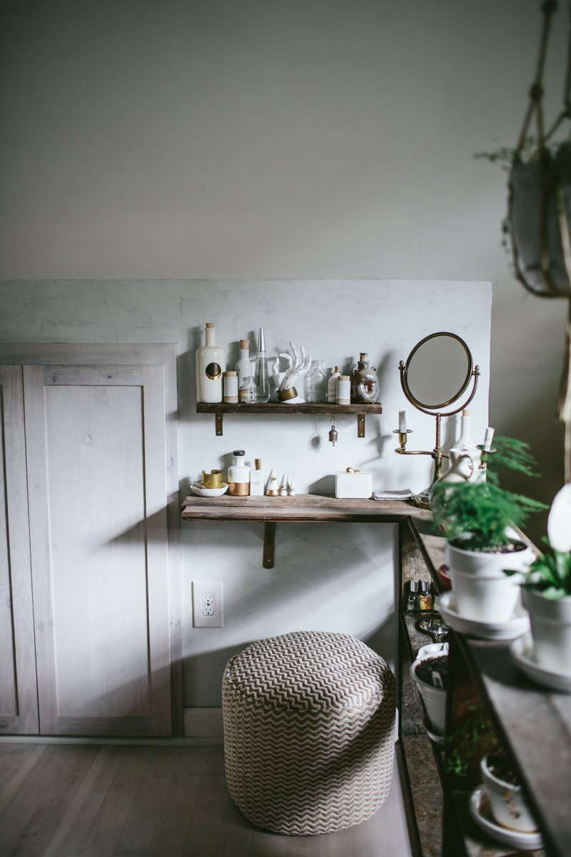 The shelving continues into a small, low-ceilinged area under the eaves, creating a built-in vanity.