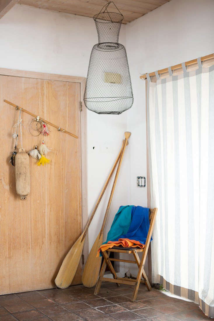On their renovated houseboat, Gabe Cohen and Jolie Signorile of Fredericks & Mae display oars and other nautical equipment. See Rehab Diary: The Ultimate Houseboat in NYC. Photography by Douglas Lyle Thompson.