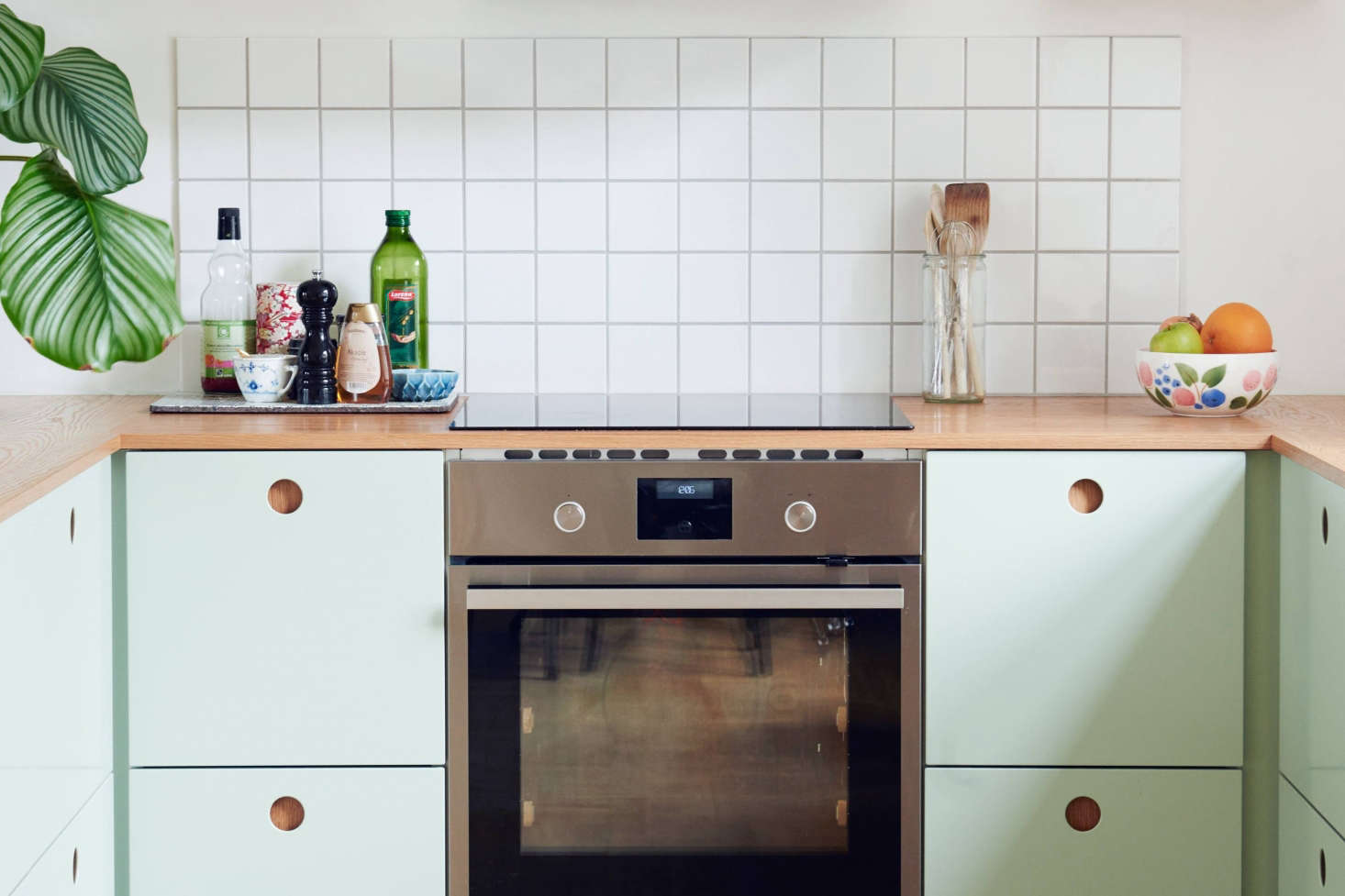 Stylish Ikea hack kitchen with mint green fronts by Reform of