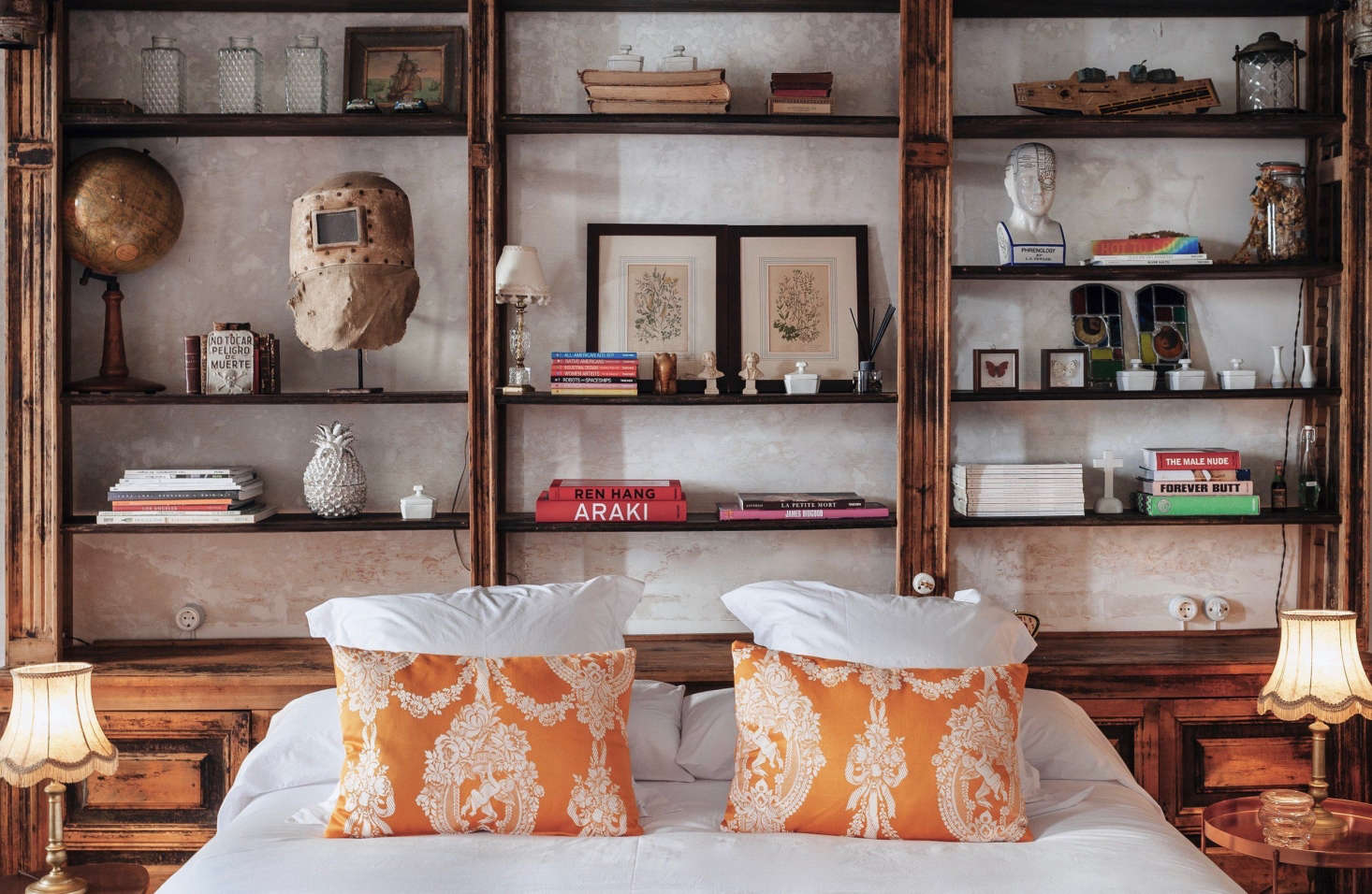 An antique sideboard shelf serves as a headboard.