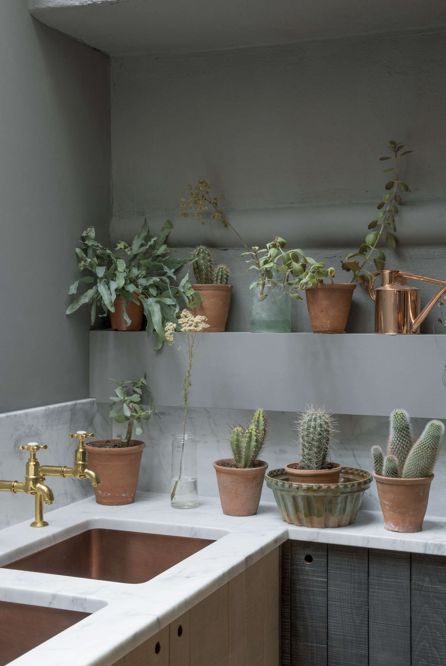 The counter is honed Cararra. In lieu of hardware, the cabinets have circular cutouts with copper edging for a streamlined look: explore the options in Remodeling data-src=
