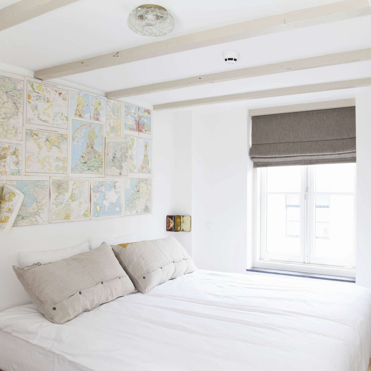 Vintage maps form an instant headboard at Hello I
