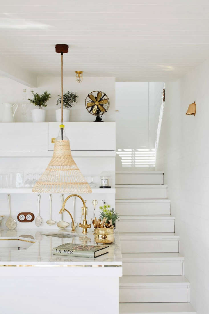 the marble topped counter is edged with a band of brass and has a custom brass  18