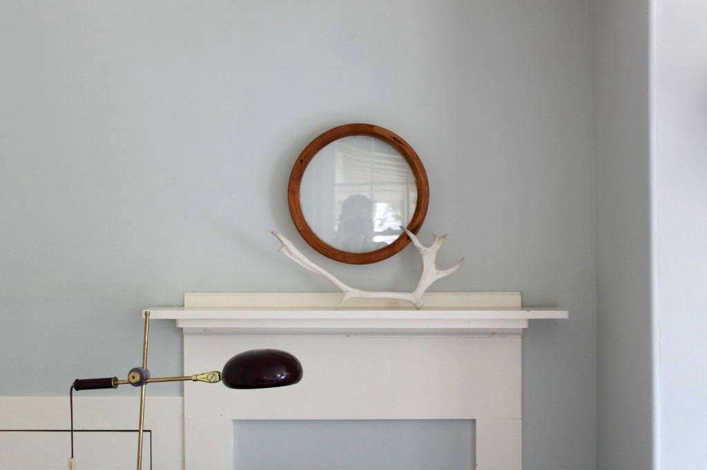 In my own Cape Cod cottage, I created a minimal mantel display by pairing a single vintage porthole with a bleached caribou antler that my stepfather found in Alaska. See more at The Soulful Side of Old Cape Cod: Justine’s Family Cottage.