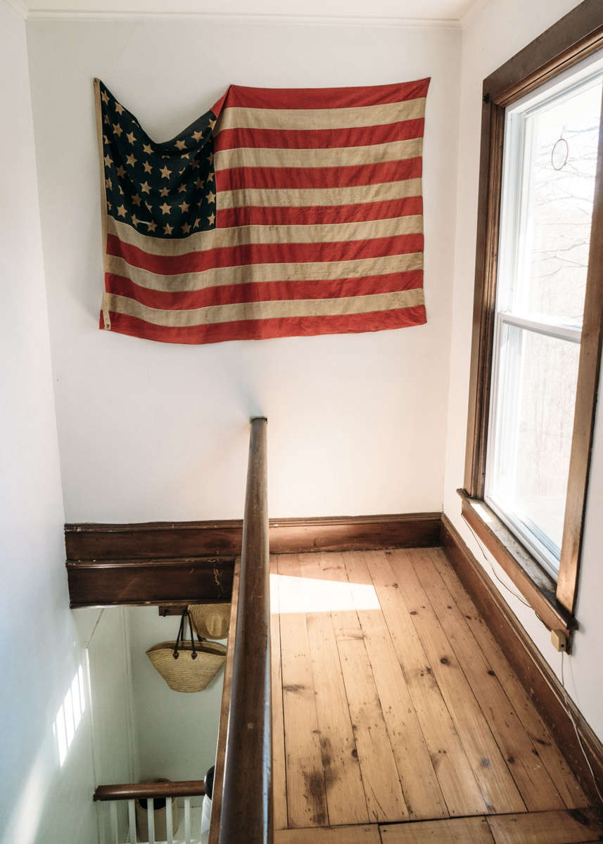 A flag, a vintage find that Przystup thinks she found at Stella Dallas Living in Williamsburg, Brooklyn, hangs above the stair landing.