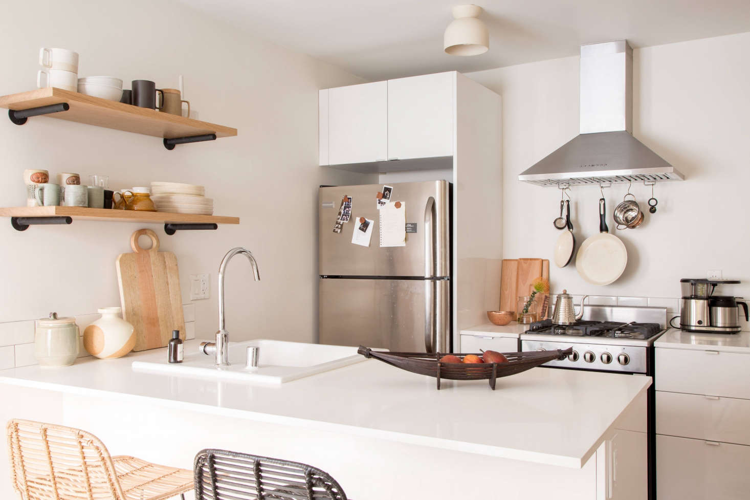 A simple switch with a big impact: If you can, swap out an existing light fixture (or cover a bare bulb) with a fixture you can bring with you from rental to rental. (Just keep the original fixture somewhere so you can replace it before you go.) Here, designer Paige Geffen swapped an existing fixture for the Terra Surface from Cedar & Moss in her kitchen. See The LA Rental, Upgraded: Designer Paige Geffen’s 500-Square-Foot Challenge for more.