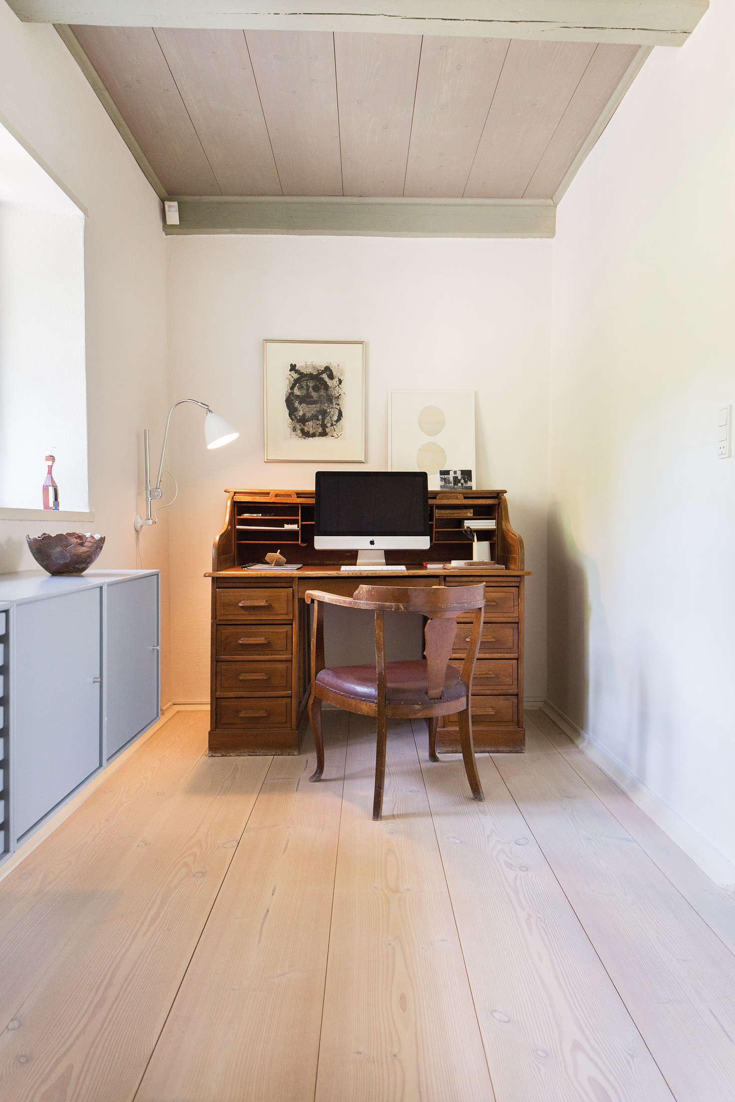 An old-fashioned secretary desk and vintage chair contrast nicely with modern pieces. Photograph courtesy of Dinesen, from The Dinesen Family House: A Historic Renovation for Danish Design Royalty.
