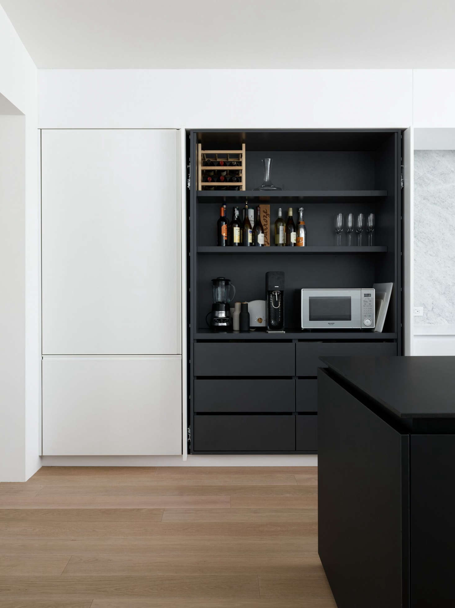 Pocket doors conceal shelving and small appliances in the Noe Valley kitchen of Robert Edmonds and Vivian Lee of Edmonds + Lee Architects.