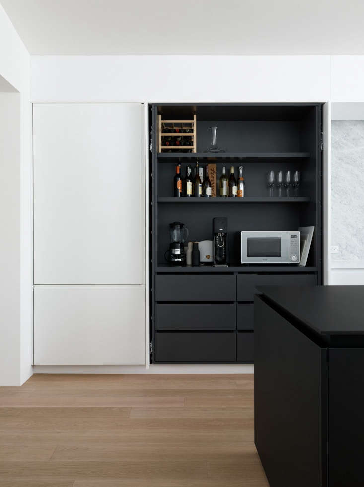 pocket doors conceal shelving and small appliances in the noe valley kitchen of 29