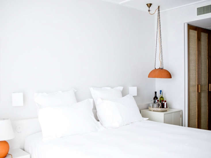 marigold hued pendant lights hang by the bedside (and above a deconstructed min 24