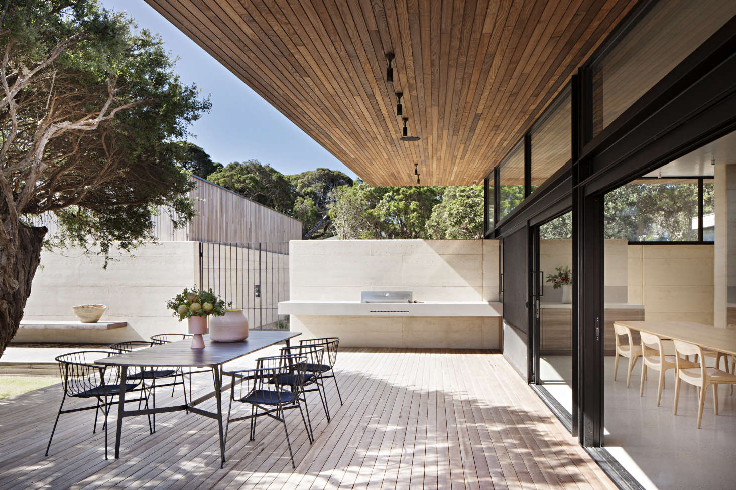 The dining terrace is paneled above and below in spotted gum, an Australian hardwood.