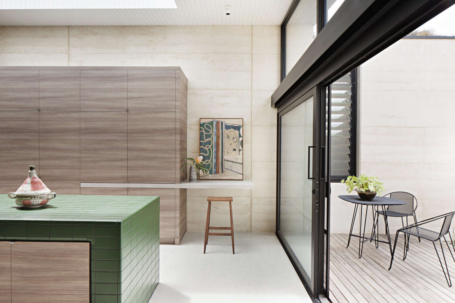 The kitchen opens to a small terrace. The large oak cabinet conceals, among other things, the refrigerator and an appliance cupboard.