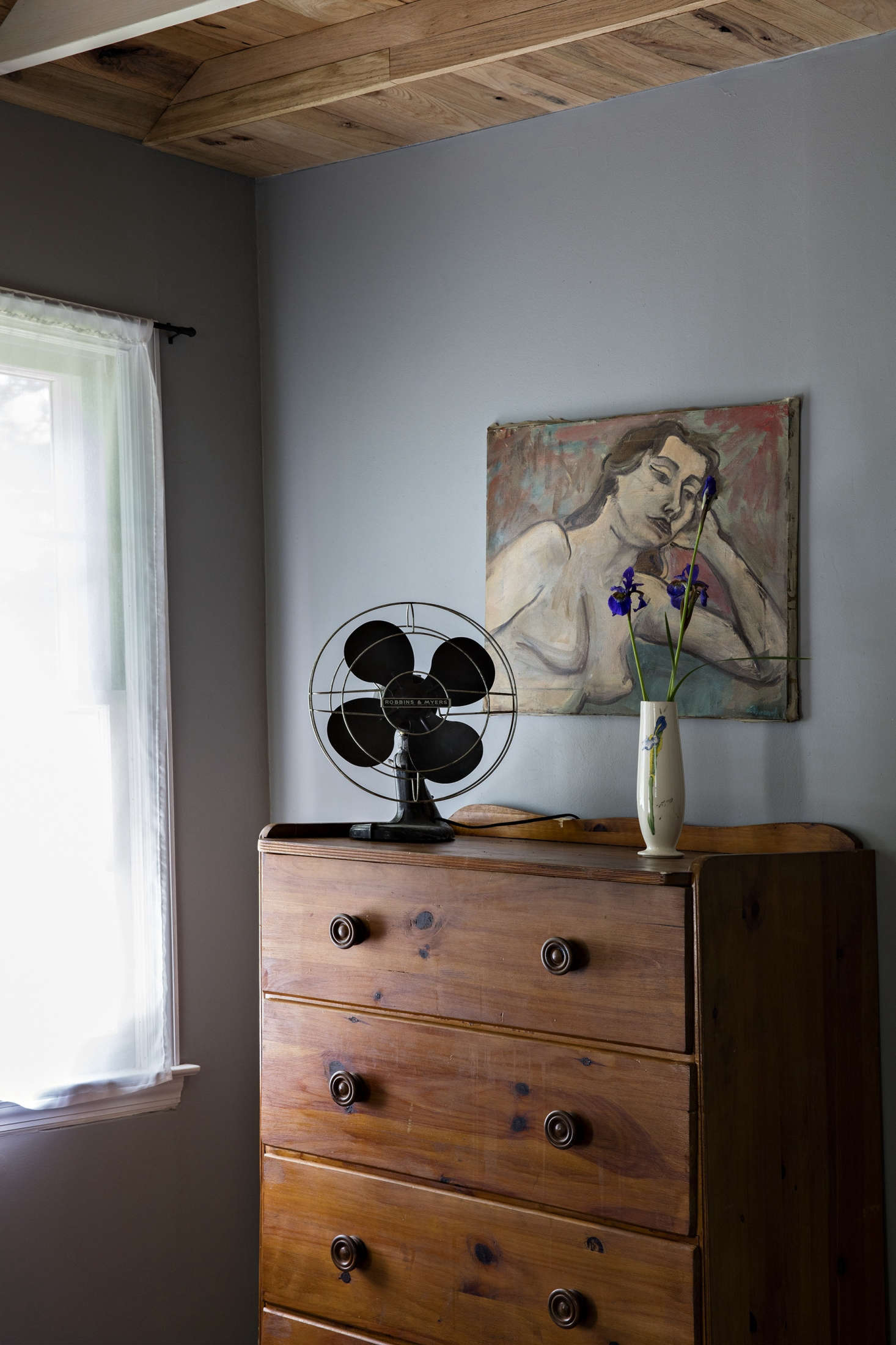 Vintage fans sit atop dressers in the bungalow bedrooms.