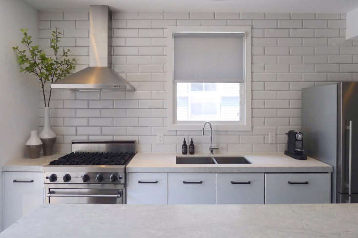 white subway tile backsplash kitchen stainless vent hood