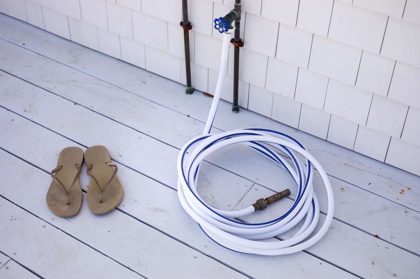 An outdoor shower and hose for after-beach cleanup.