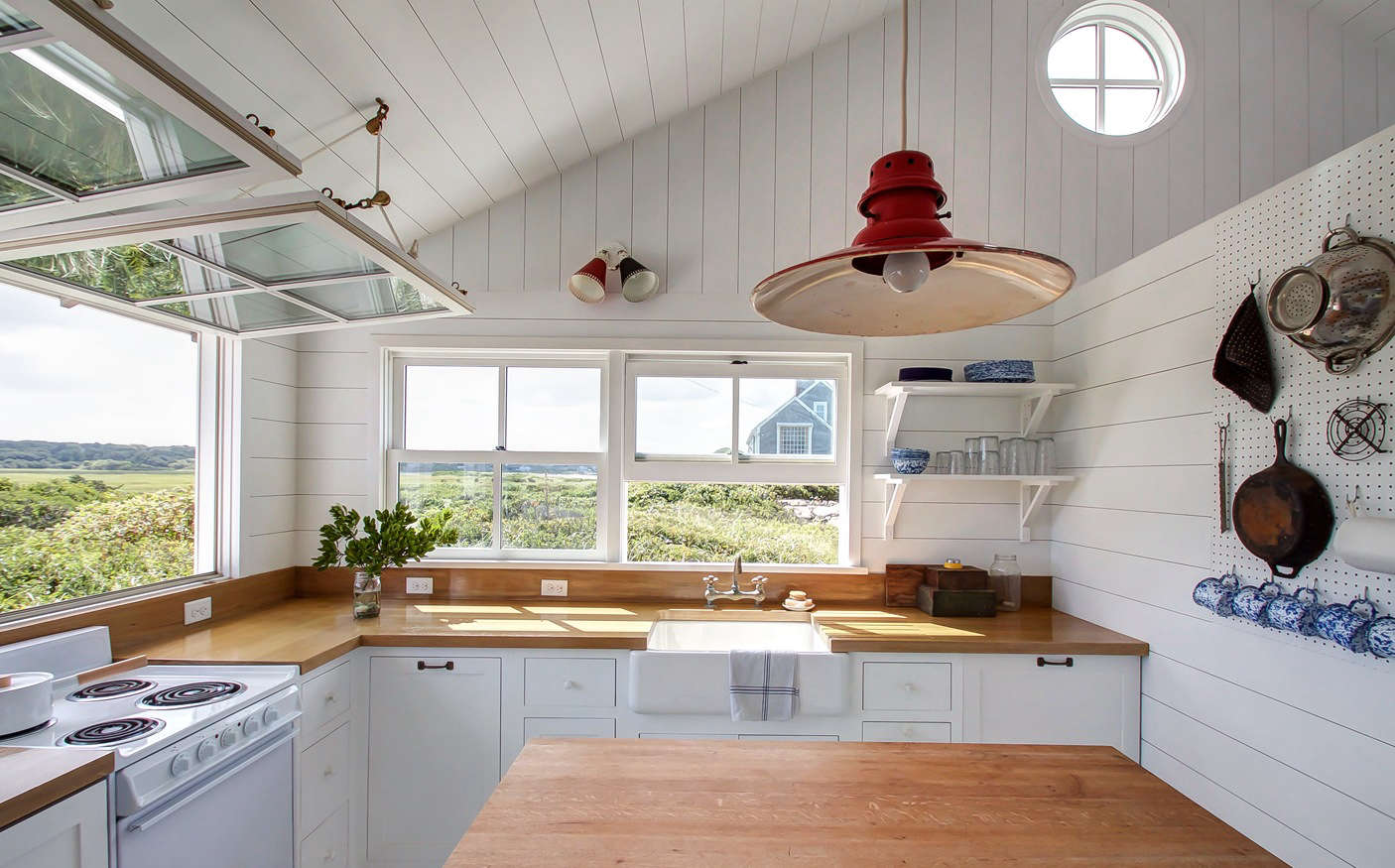The light fixtures are all vintage; a double sconce from Amsterdam and a red barn light from data-src=