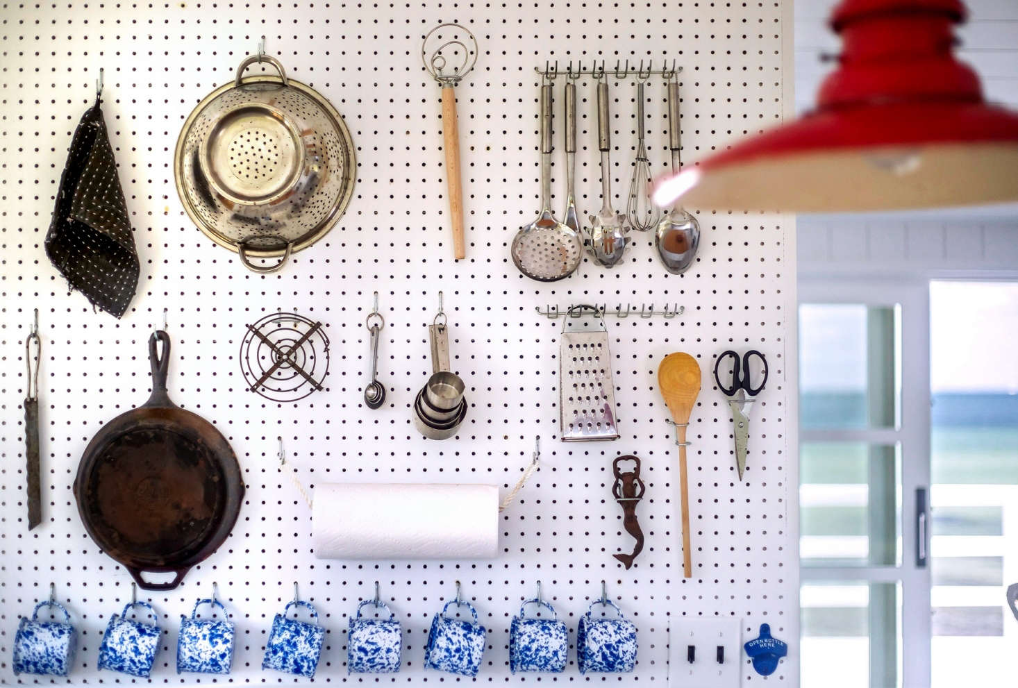 A Julia Child–style pegboard holds a kitchen