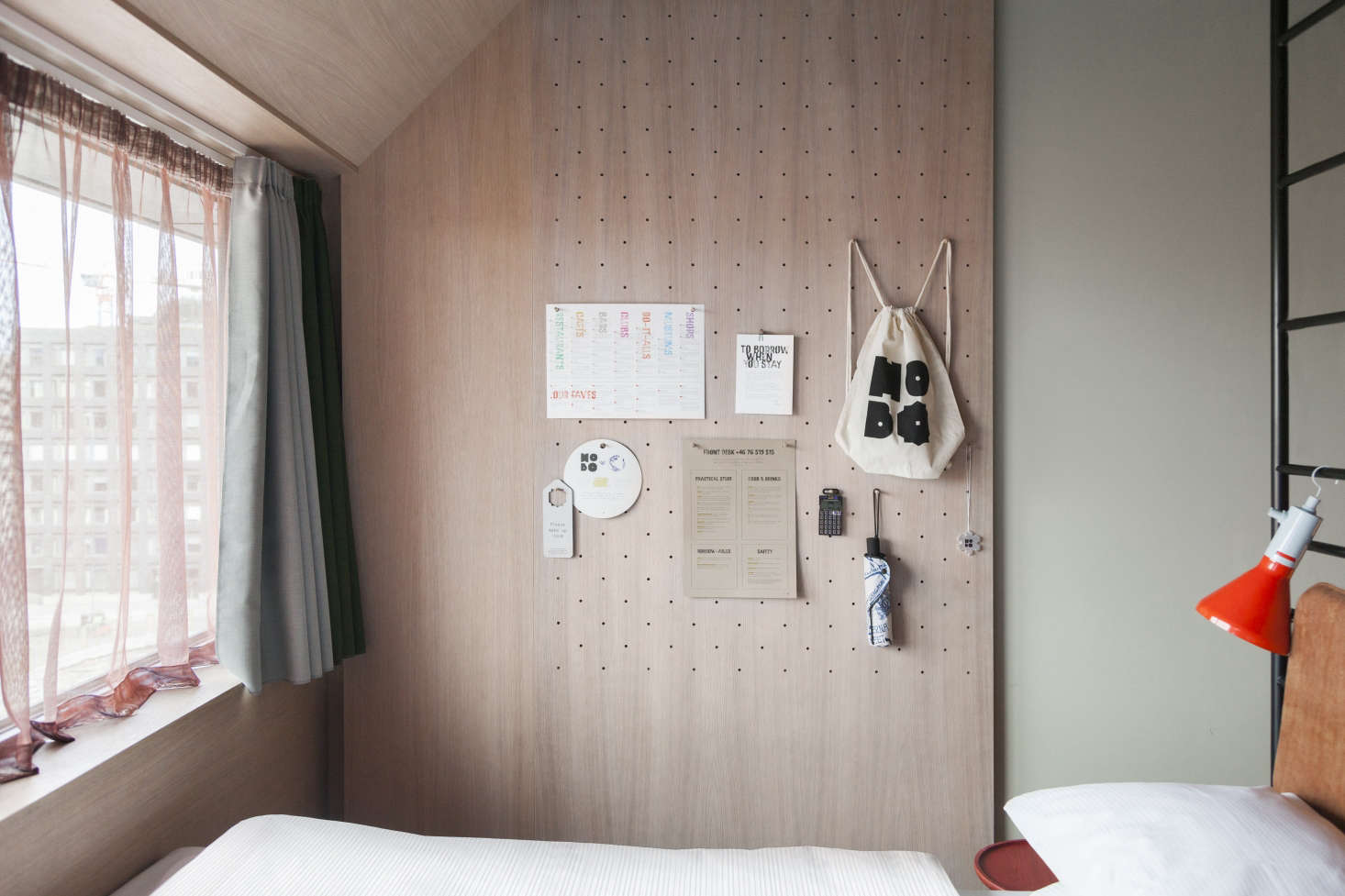 Deployed at the Hobo in range of ways, including as vertical paneling, pegboards also provide a place to display schedules, artwork, tips guests can leave for the next occupants, and hotel accessories (a backpack, umbrella, and pocket synthesizer for use during their stay and to buy if they wish).