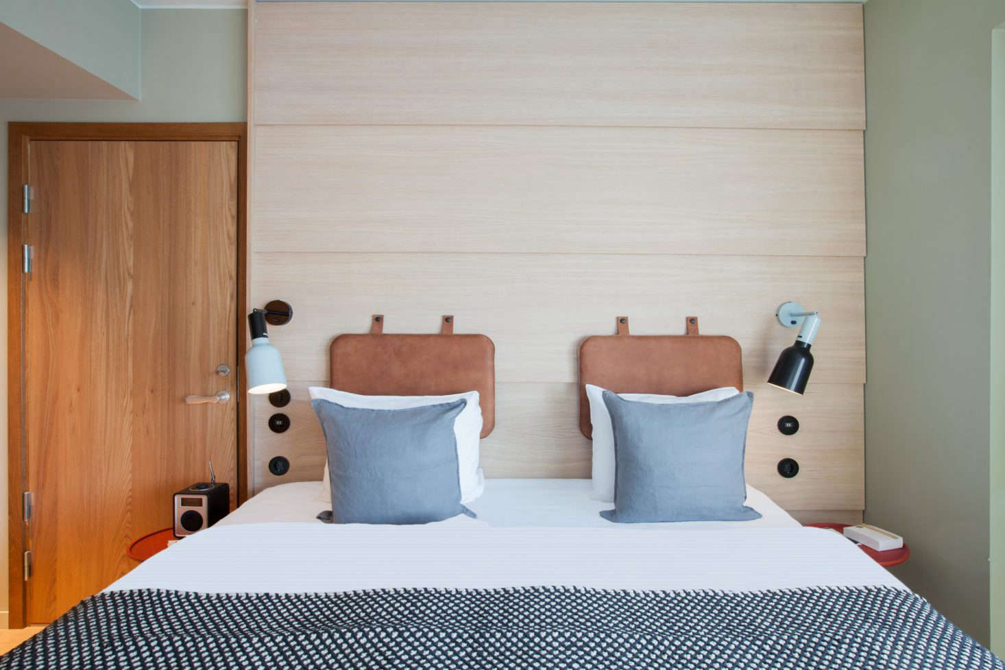 A look borrowed from vintage gym mats: upholstered leather panels affixed to the wall (or lattice bed divider) as a headrest. Leather was selected to add texture and warmth to the room, and because it improves with age, but canvas and other fabrics would also work well. Photograph by Patricia Parinejad.