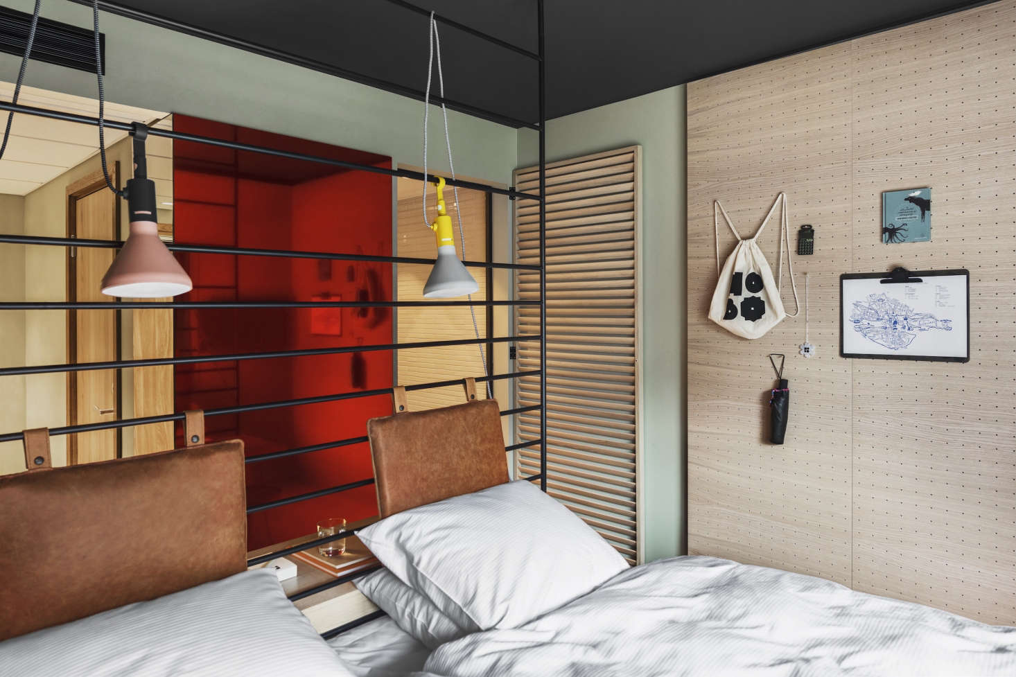 Introducing mirrors is an age-old way to create the illusion of extra square footage. Studio Aisslinger added a surprise touch: a rose-colored mirror that contrasts with the pale green-gray walls.