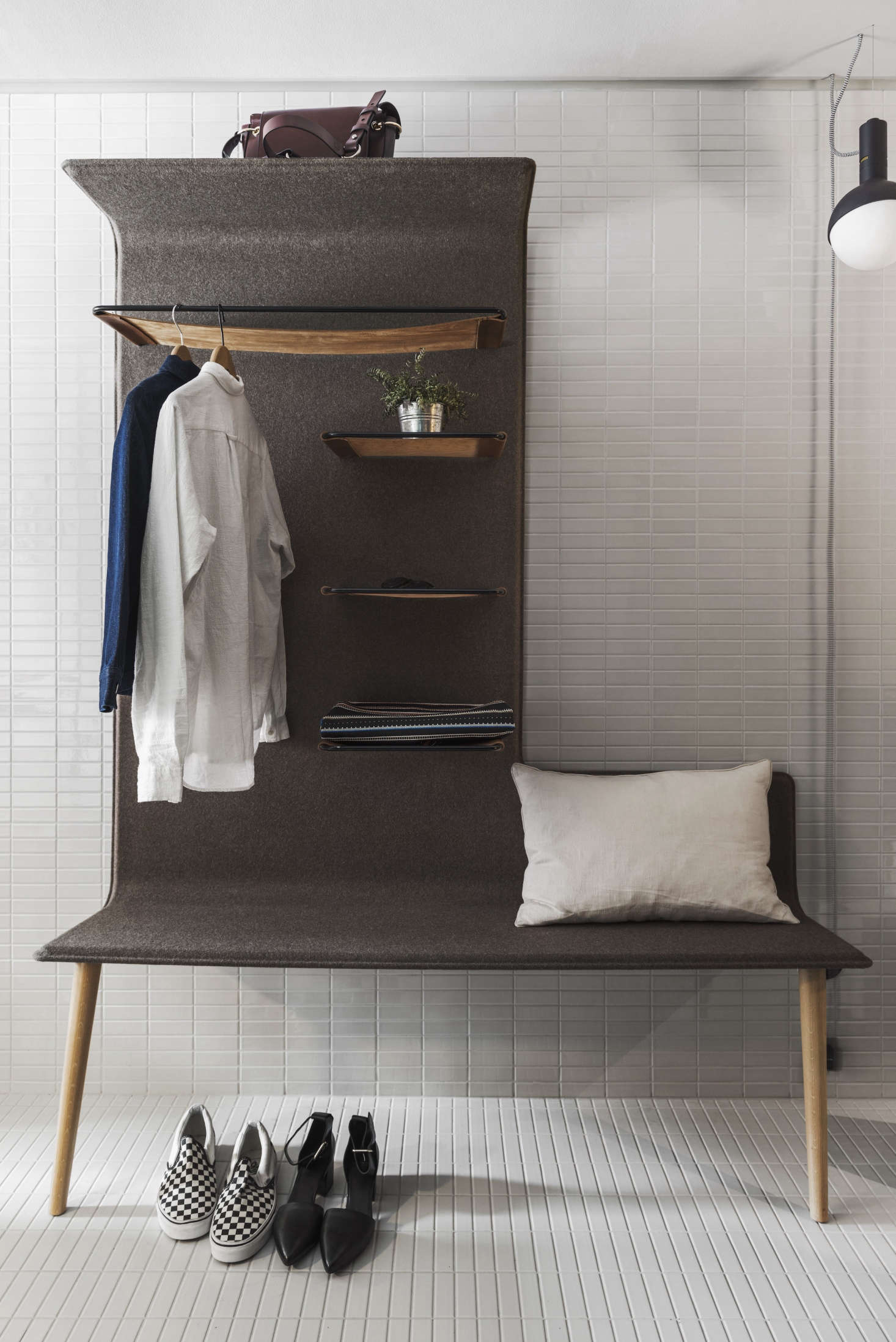 A Studio Aisslinger felt-fleece-lined bench incorporates shelves and a hanging rack.