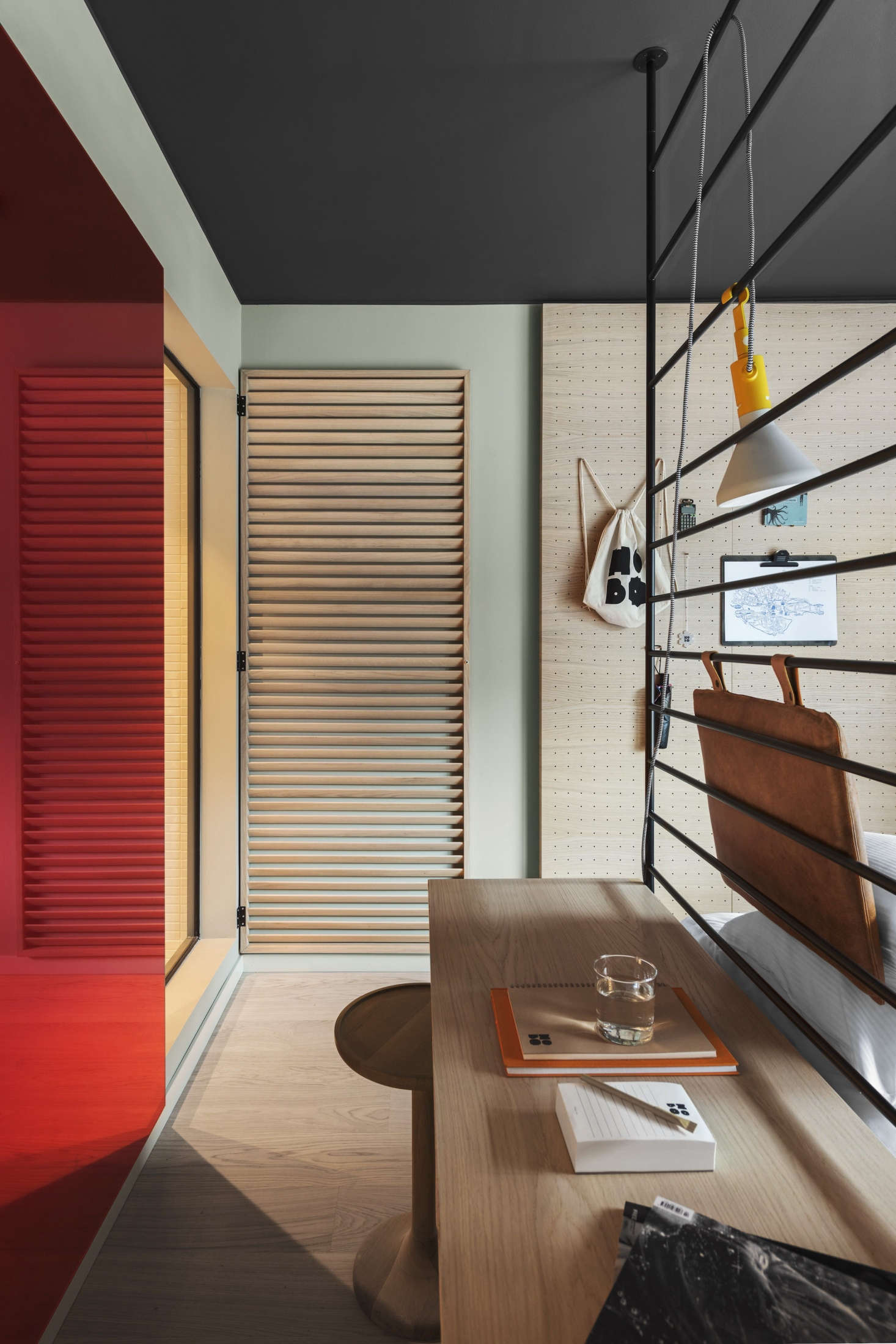 In tight spaces it makes sense for the key furnishings to multitask. On boats and trailers, drawers are inserted into stairs, and kitchen tables morph into beds. Here, the lattice-framed bed doubles as a desk. Photograph by Erik Lefvander.