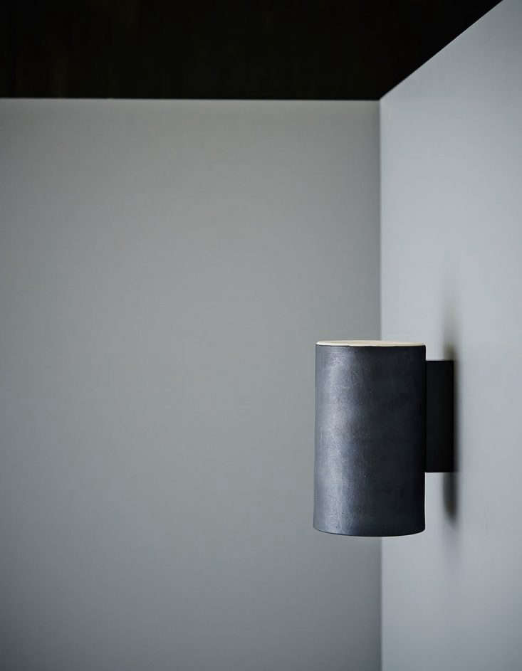 the earth wall light in a charcoal glaze finish. 18