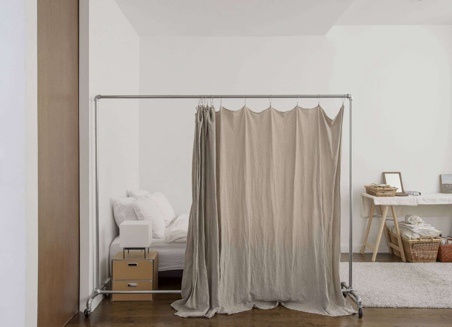 For a softer divider, we like the idea of curtains, but hanging one from the ceiling requires hardware and drilling holes. For less impact, try this hack from shopowner Makié Yahagi