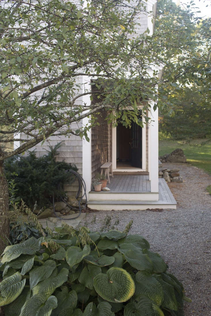 a pocket porch on the side of the house shelters the main entrance. photograph  20