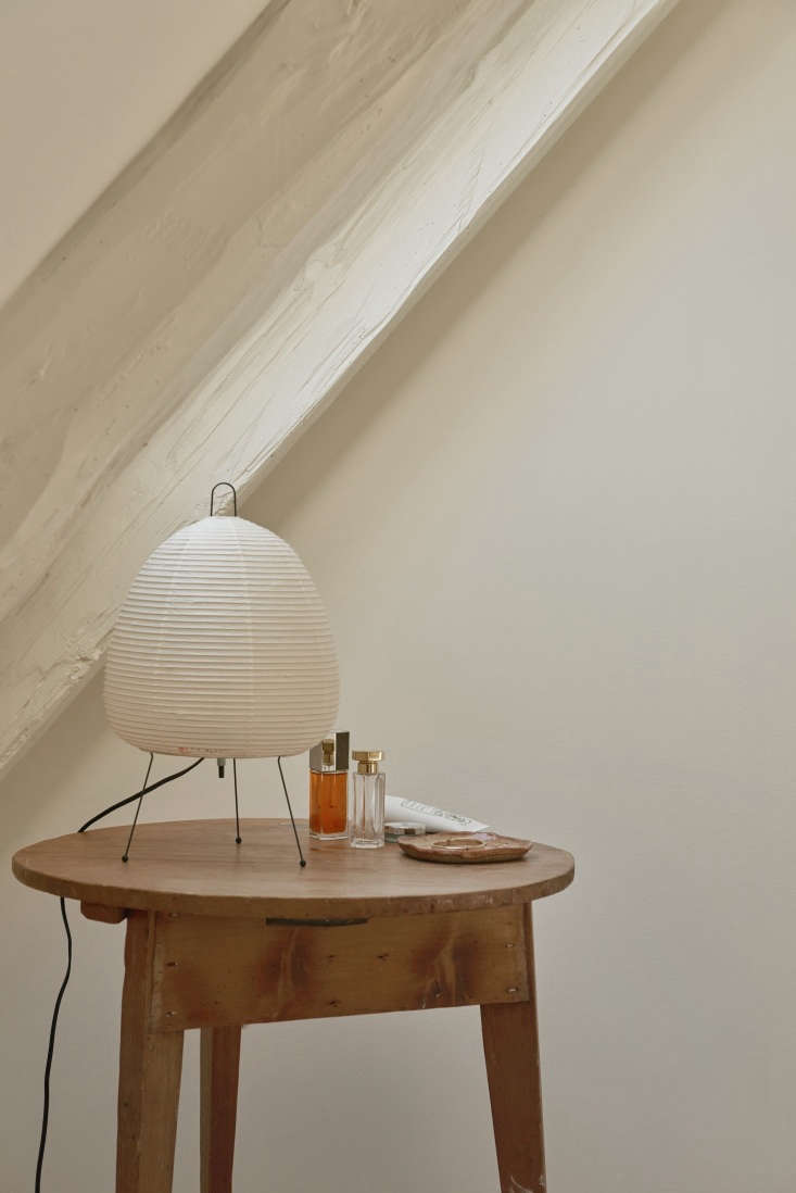 a noguchi akari \1a table lamp and toiletries on a vintage side table. 27