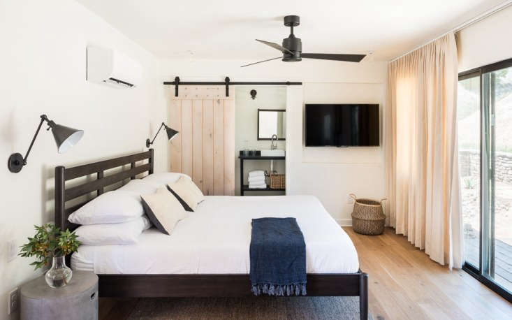 another guest suite has a sliding barn door separating the bath. the indigo thr 27