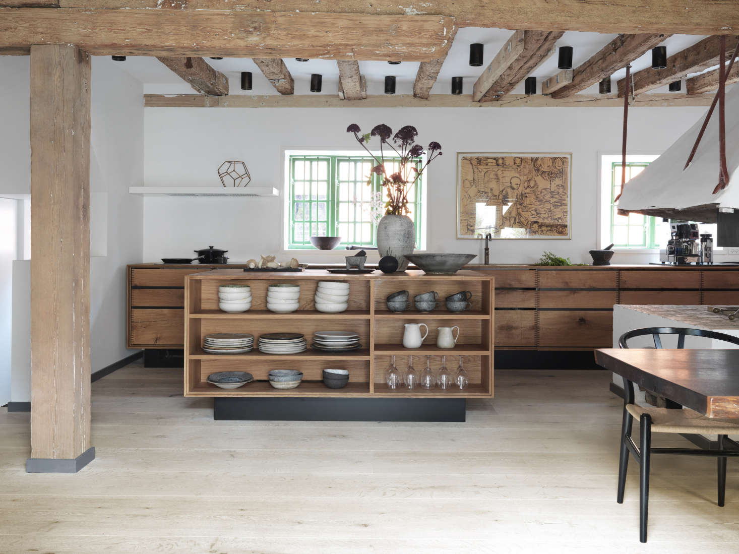 Open shelving on one side of the kitchen island keeps ceramics from Noma on display.