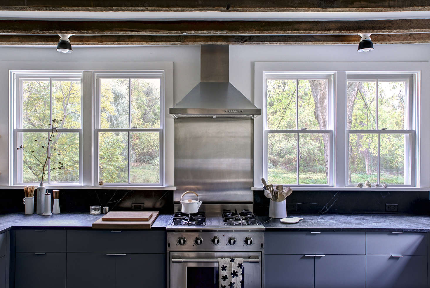 Dunja replaced three small, central windows with four more generous specimens from Marvin, which now frame a NXR stove and make the most of the woodland view.