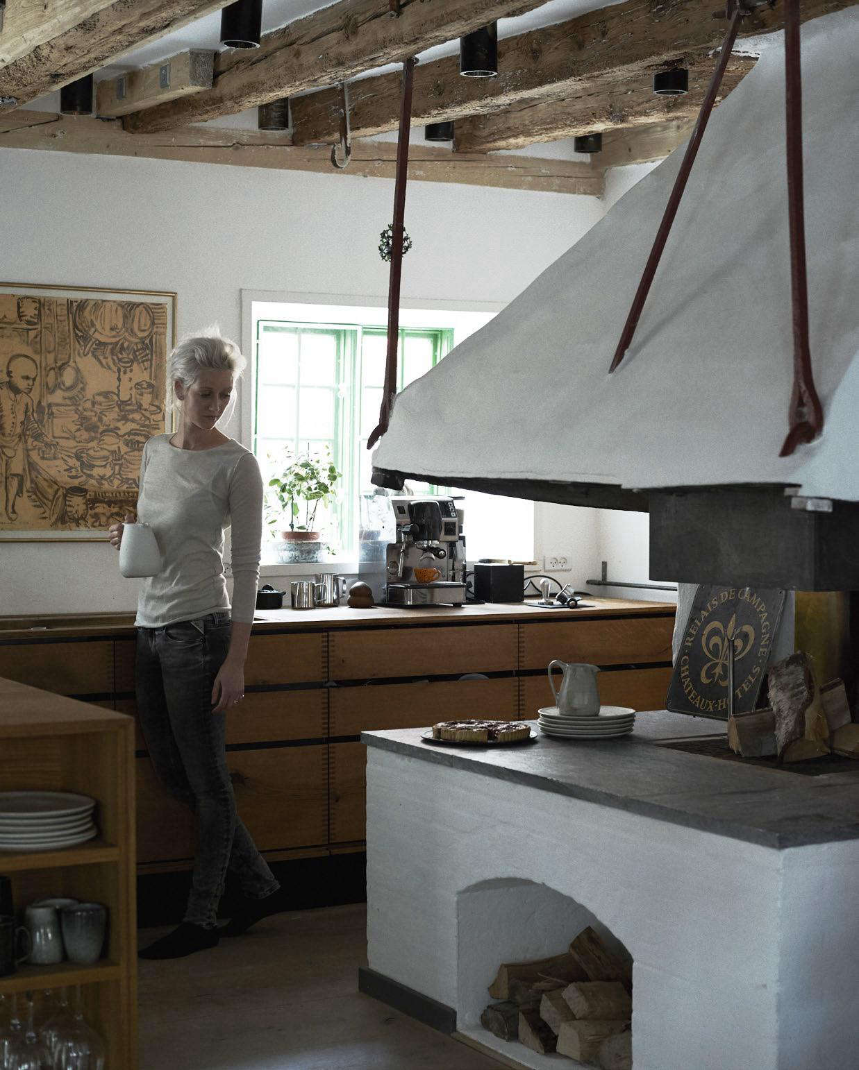 Nadine by the woodstove. Photograph by Ditte Isager.