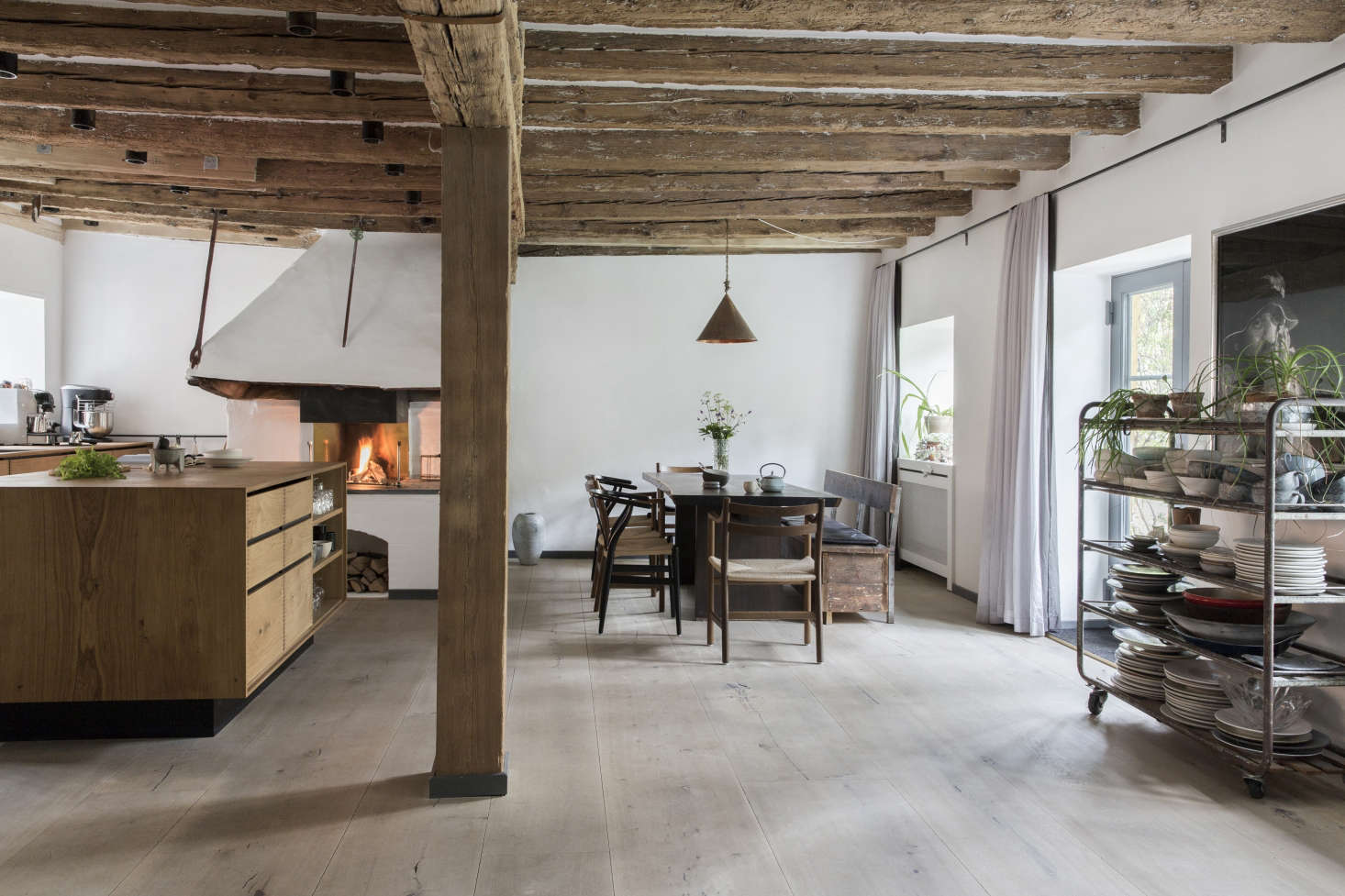 The couple enlisted Garde Hvalsøe, three cabinetmakers, and an architect working with Dinesen wood to create their custom family kitchen. Photograph courtesy of Dinesen.