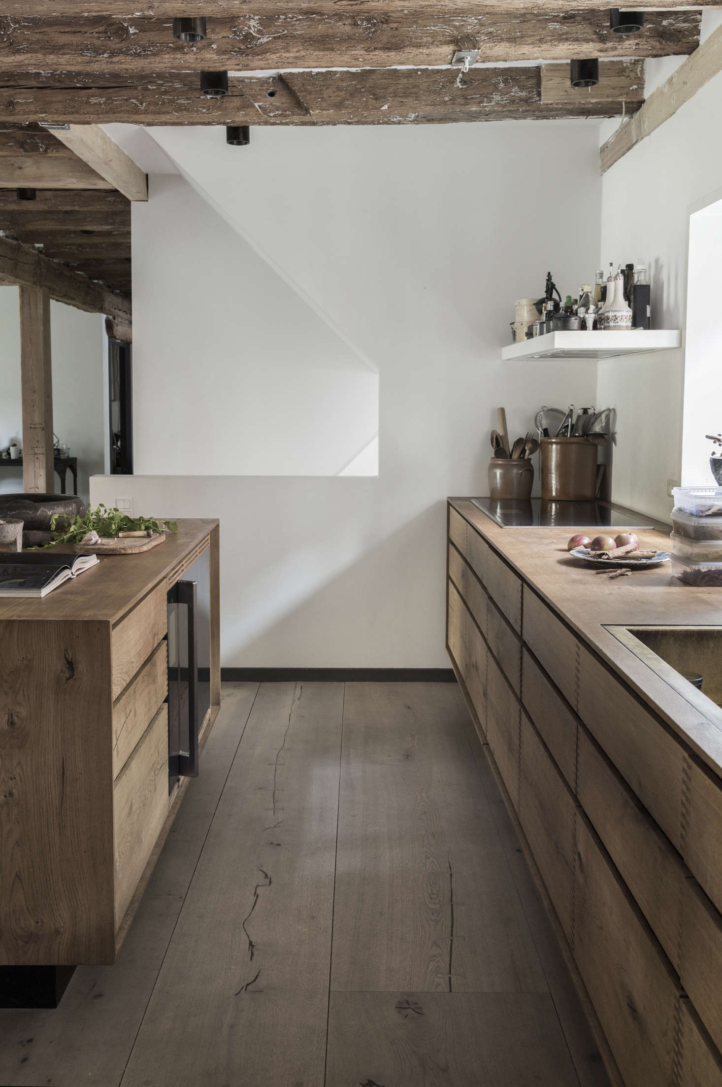 Cooking essentials are kept near the stove, including on the vent hood above. Photograph courtesy of Dinesen.