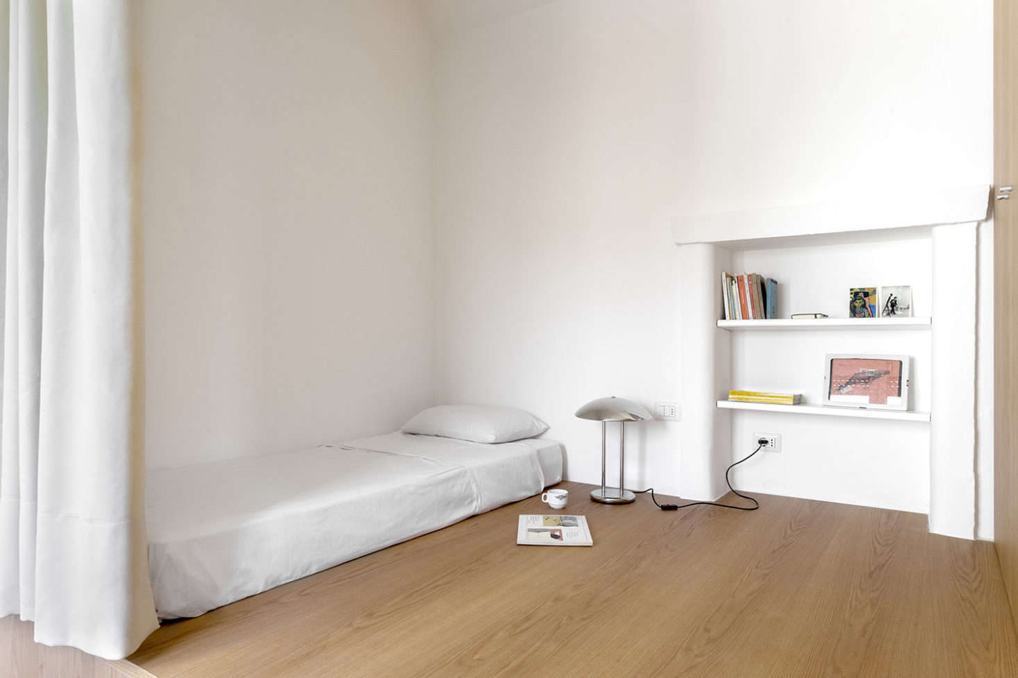 Monastic chic: A curtained bedroom in Milan by Casatibounsante Architects. See The Small-Space Bedroom: 8 Ideas to Steal from a Stylishly Efficient Apartment. Photograph by Francesca Iovene, courtesy of Casatibuonsante Architects.