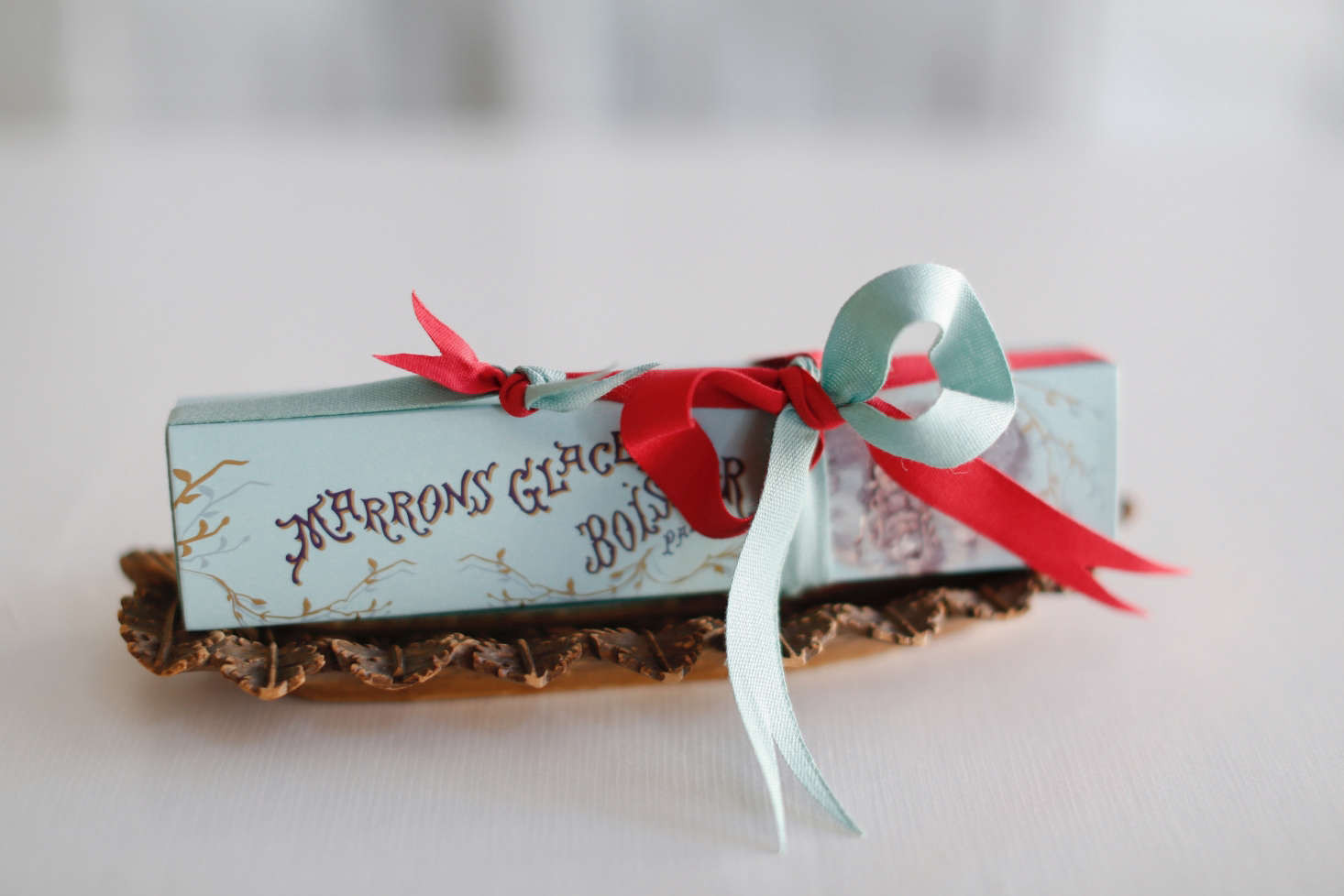 Claudia invented a clever use for the ribbon scraps lying around her store: She ties the ribbons together end-to-end to make two-toned bows.