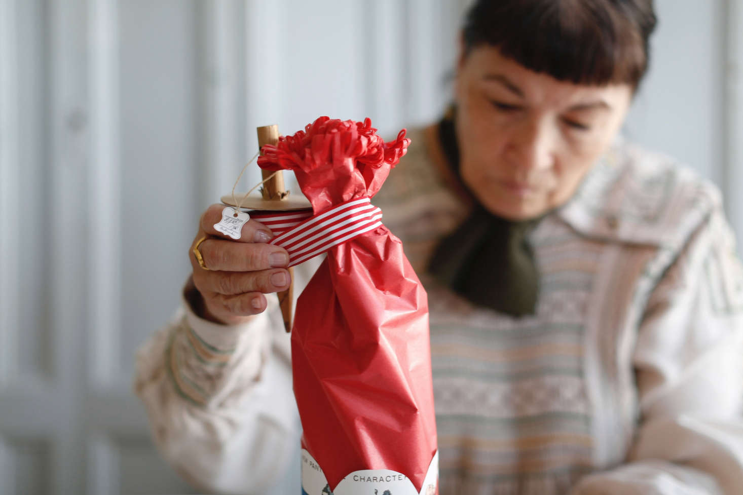 Step 5: Firmly bunch the tissue paper around the neck of the bottle, then fluff the fringe so it looks like a rosette on top.