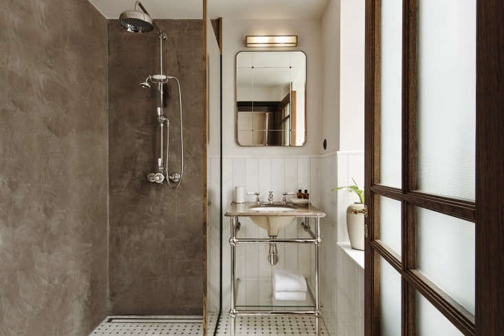 inside a guest bath, vintage style vanity and plaster walls included. 25