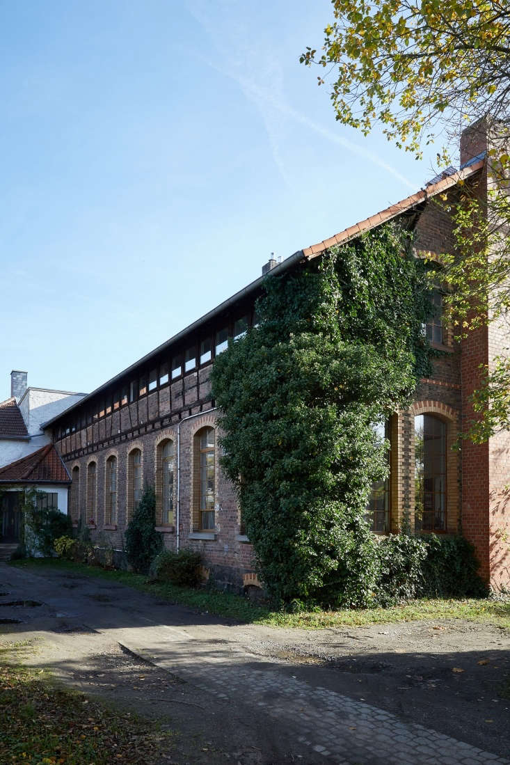 the building is made of multicolored brick with a band of clerestory windows ov 36